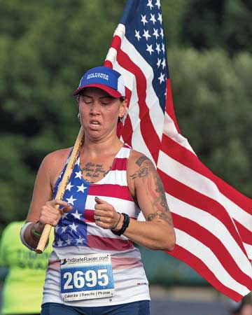 Katie Davis running with American Flag